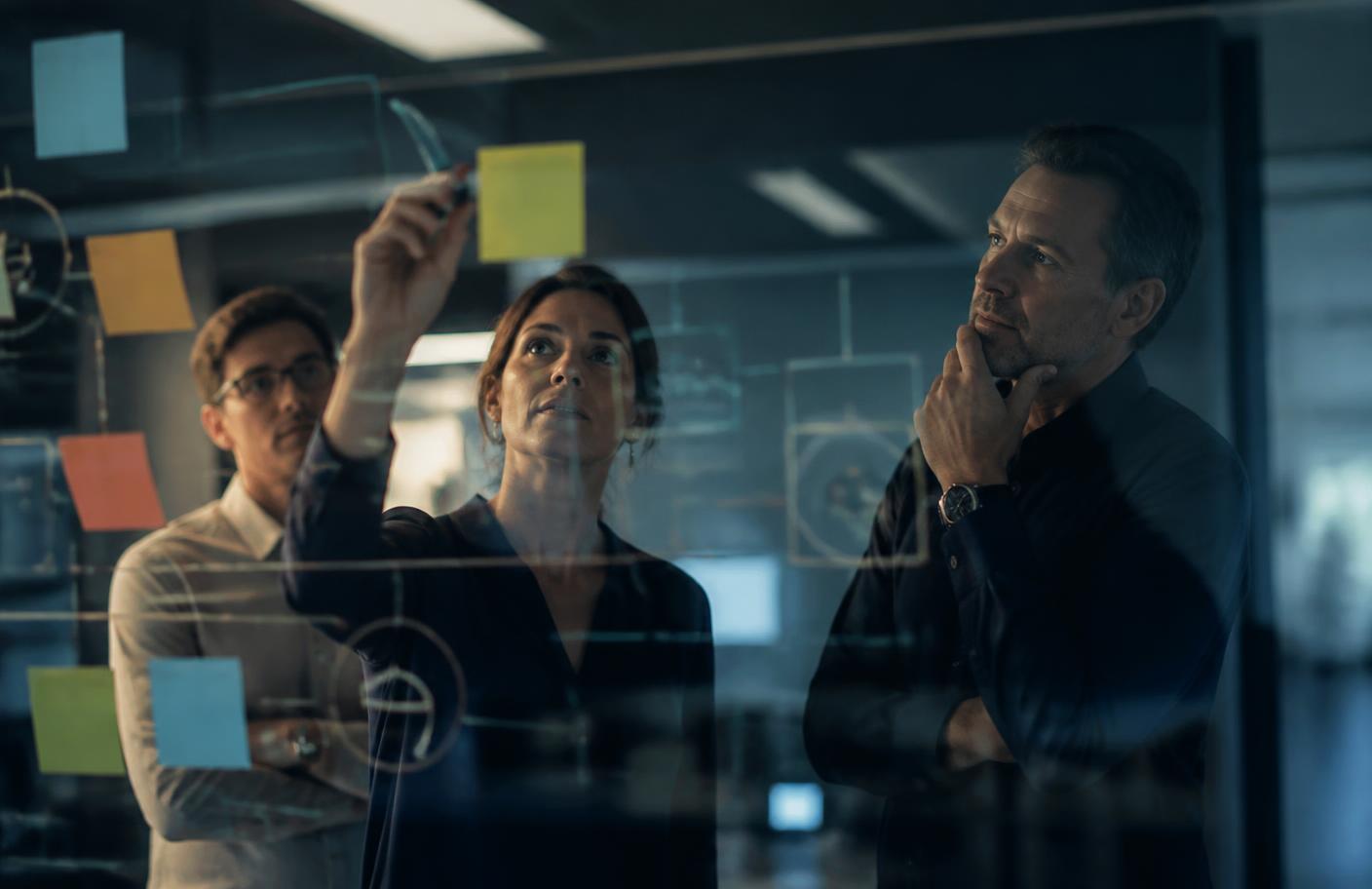 Avello team mapping a client workflow on a glass planning wall
